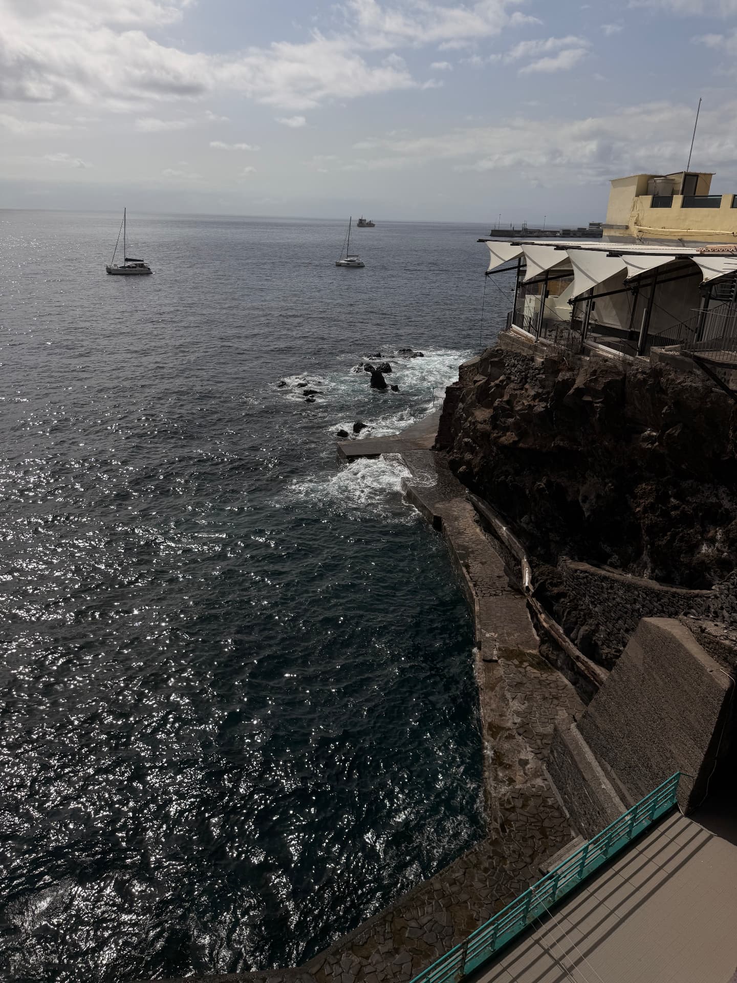 Sea view from Barreirinha Bar Café over the rocks and sea-bathing steps, Funchal