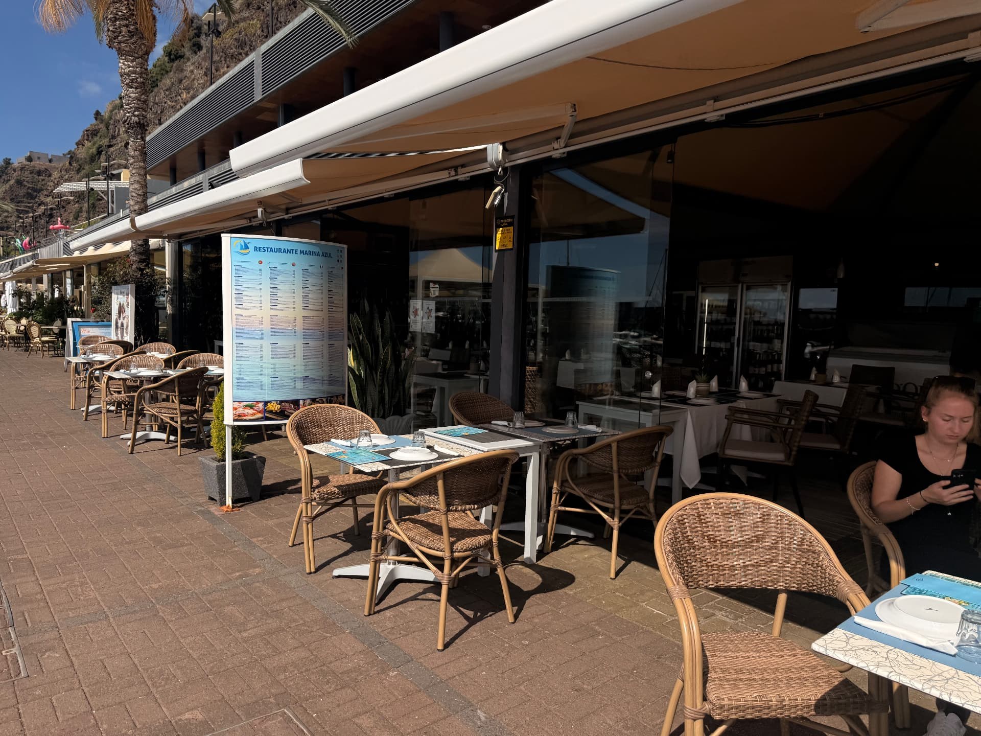 Marina Azul restaurant terrace and menu board at Calheta marina.